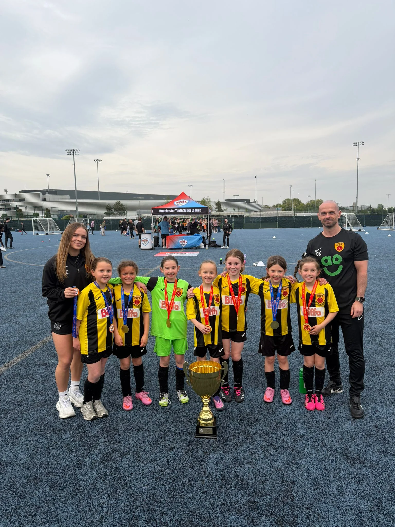 Bolton Town Rabbits squad with their trophy and medals