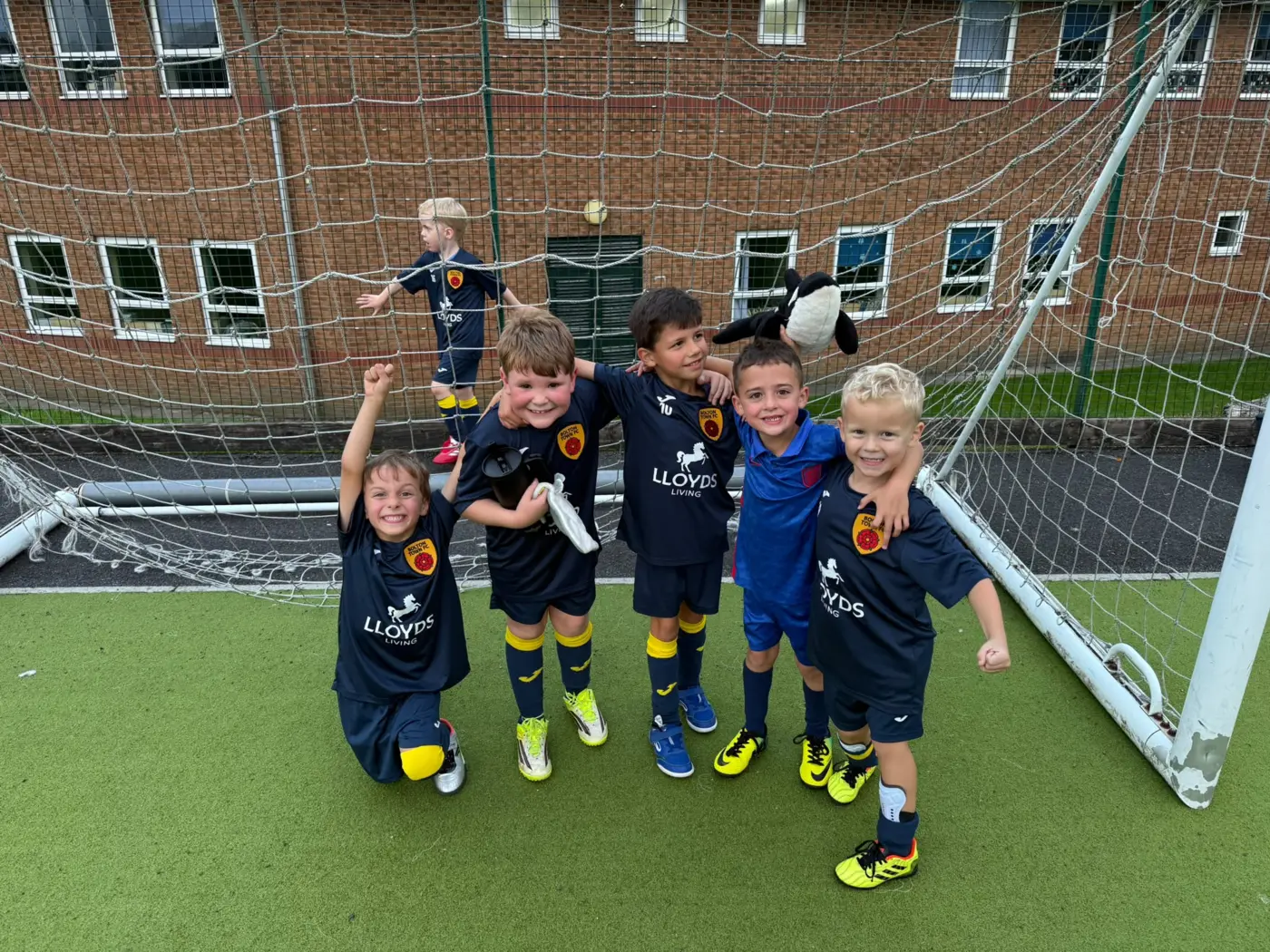 Bolton Town boys enjoying football together in front of the goal