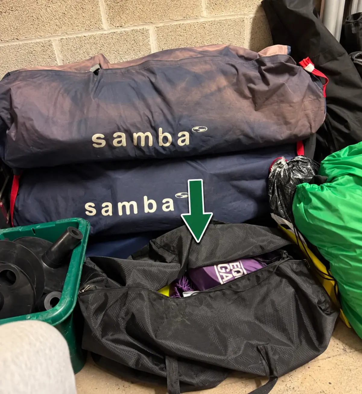 Purple pitch bags stored with the cones and other pitch equipment