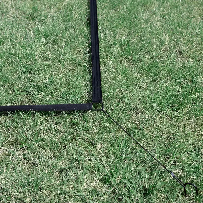 Close-up of Ziland 3v3 marker tape corner and securing peg on grass