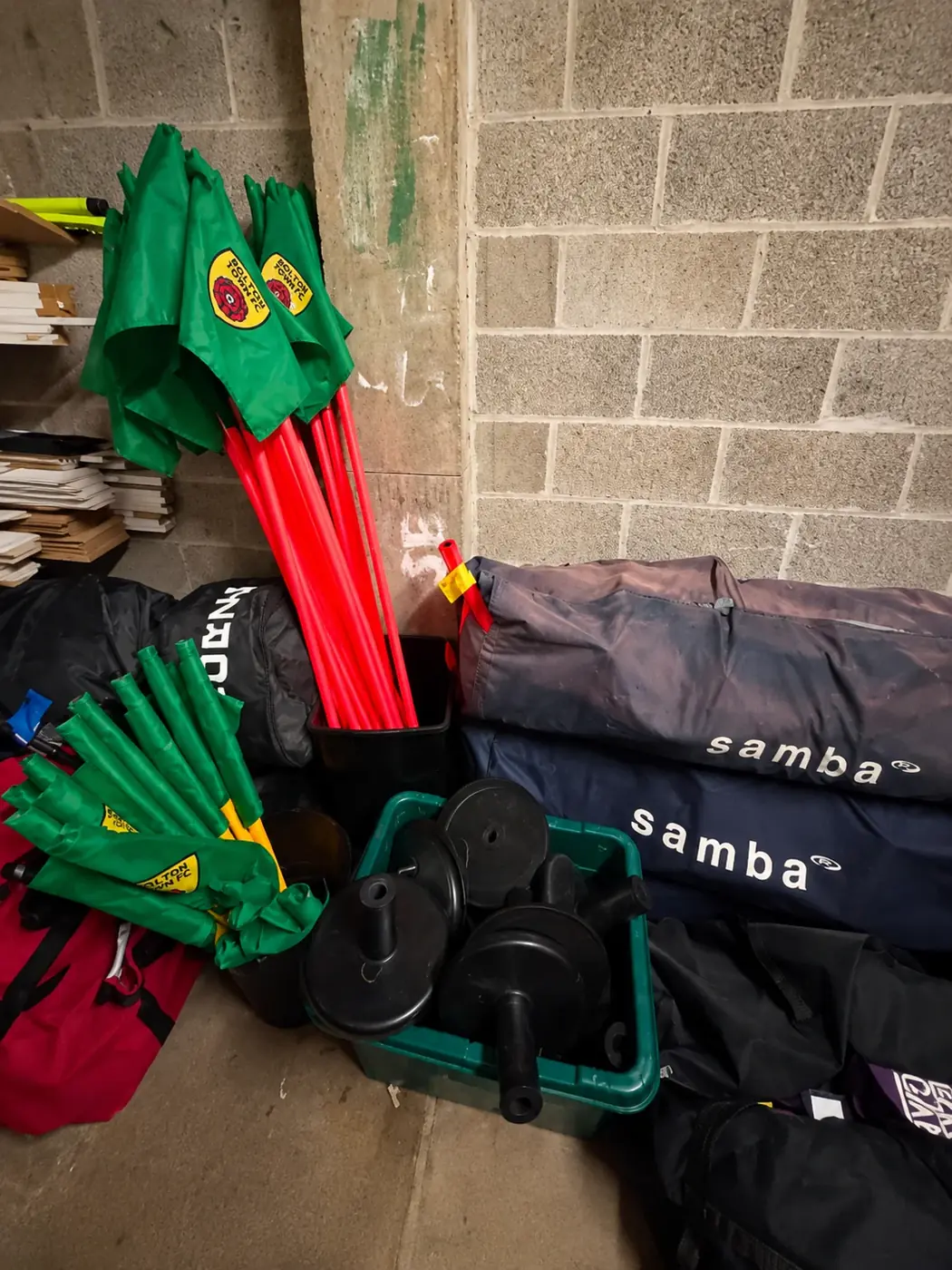Corner flags stored upright beside their weighted bases
