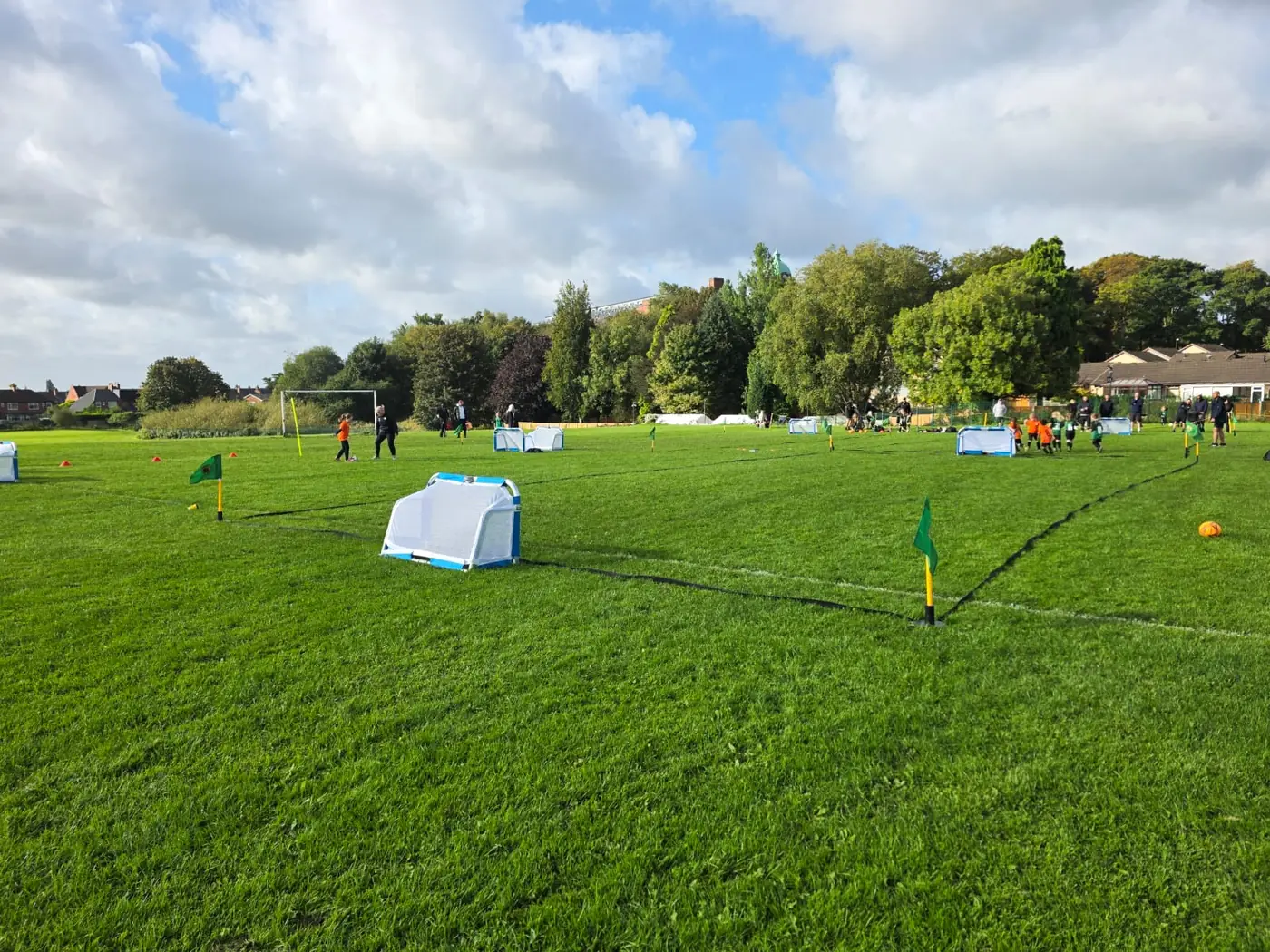Real 3v3 grass pitch setup at Sharples showing small goals, marker tape and small corner flags